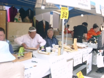 和紙封筒の展示販売をする若林さん（右）と手書表札の実演製作をする浅水屋さん（左）