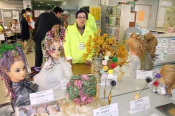 日本の伝統を伝える編み込みヘア作品の数々。写真右手前は、10本の水引を使い、慶弔、陰陽の色を組み合わせて作った「十編み花」。