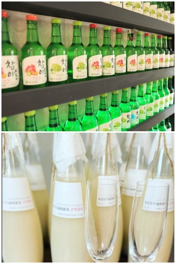 酒瓶のディスプレイ棚。希少品のシャンパンマッコリは要問合せ。「サムギョプサルと韓国酒場 テジヤ」