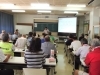 熱心にメモを取りながら聞き入る受講生 =狭山元気大学 大会議室