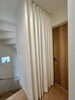「階段の間仕切りに設置したカーテン」