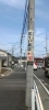 お店前の電柱看板です「高尾街道からの入り方と駐車場のご案内」