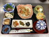 「ジューシーな鶏唐揚げ油淋鶏にお刺身や角煮など多彩な小鉢が並ぶ家庭的でほっとする本日の日替わりランチ」