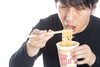 カップラーメンを食べる男性「夜遅い時間の食事を避けたい理由」