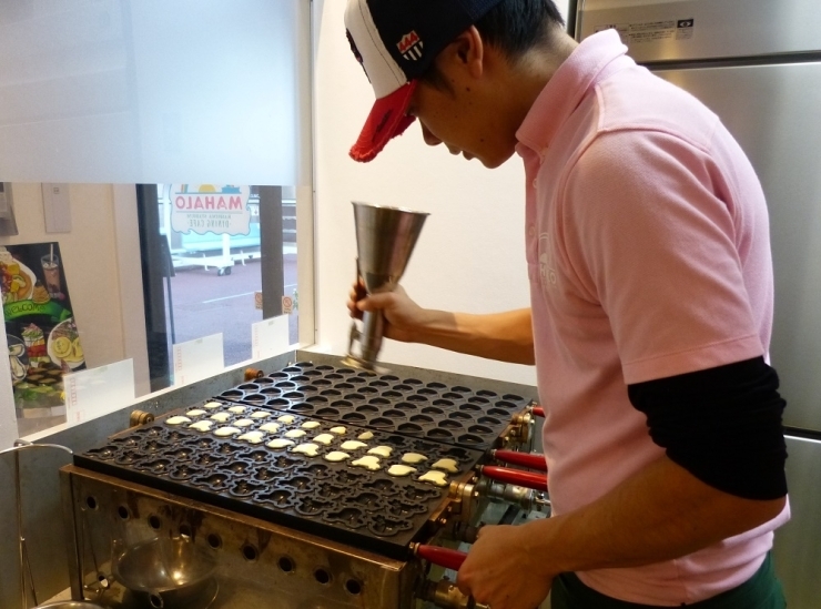 焼き型目がけてリズミカルに生地を注入