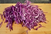 【2】紫キャベツを千切りにし、ボウルに入れて<br>塩小さじ1/2をまぶす。<br>5分くらいたったら水気を軽く絞る。