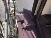 下屋根 壁際、雨押板金施工「【施工事例】ワインレッドの屋根で蘇る!カバー工法で美観と性能アップ」