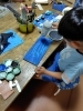 青い海を絵の具で描いて今乾かしてます。「A君のシャチ完成しました。」