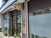 路地裏にある店舗。看板を目印にご来店ください。「カットハウス 和～nagi～」